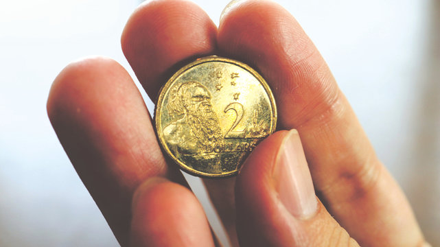 Close the Holding Australian Dollars Coin on Hand and Finger