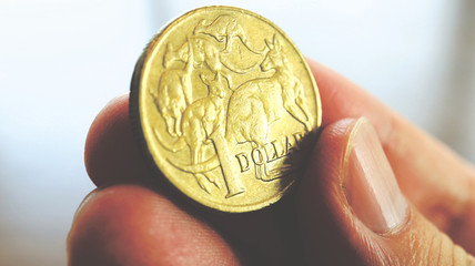 Close the Holding Australian Dollars Coin on Hand and Finger