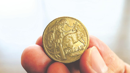 Close the Holding Australian Dollars Coin on Hand and Finger