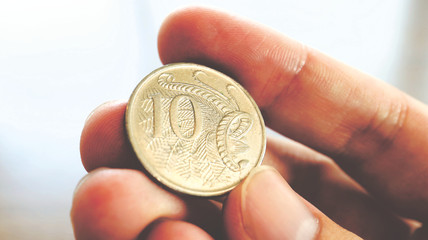 Close the Holding Australian Dollars Coin on Hand and Finger