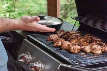 Yummy meat on the grill in the garden with spicy  taste