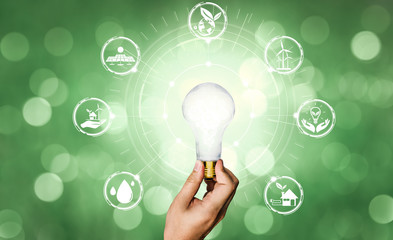 Green energy innovation light bulb with future industry of power generation icon graphic interface....