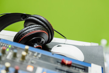 Selective focus headphone for sound engineer in the recording studio.Mixer sound equipment for playing and mixing a song in the audio sound lab.Musician entertainment tool concept.Vintage style.