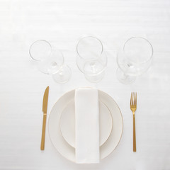 Gold cutlery knife and fork , wine glasses on  the stone background for restaurant dinner concept.