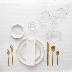 Gold cutlery knife and fork , wine glasses on  the stone background for restaurant dinner concept.