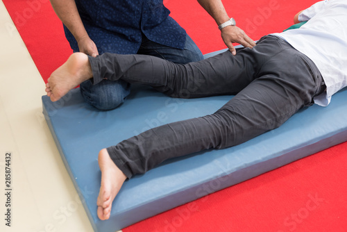 Young Working Man Lying Down While Enjoying The Stretching - 