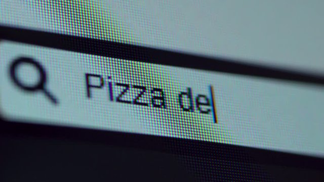 Browser bar with Pizza Delivery text typed on the computer screen. Shot in 4k resolution