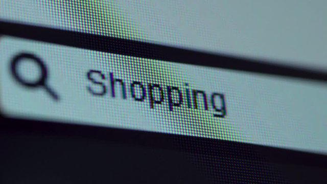 Browser bar with Shopping text typed on the computer monitor. Shot in 4k resolution