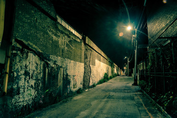 Dark and eerie urban city alley at night