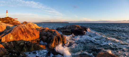 Beautiful Panoramic view of a rocky ocean coast during a vibrant sunny sunset. Taken in Lighthouse...