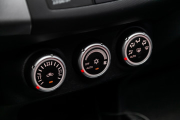Modern black car interior: climat control view with air conditioning button,.