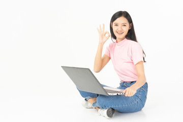 Happy asian teen passenger listening to the music with headphones while holding  mobile phone.businesswoman listening to music with headphones while dancing isolated over white background
