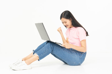 Happy asian teen passenger listening to the music with headphones while holding  mobile phone.businesswoman listening to music with headphones while dancing isolated over white background