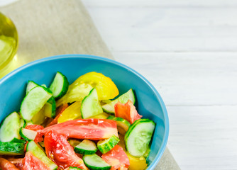 summer salad with cucumbers and tomatoes on white background