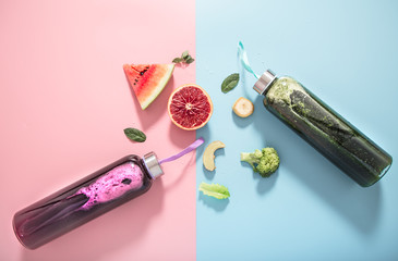 Glass bottles with natural drinks on a colored background