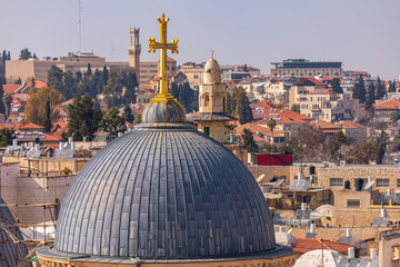 Fototapeta na wymiar The dome and golden cross of Church of the Holy Sepulchre in Jerusalem