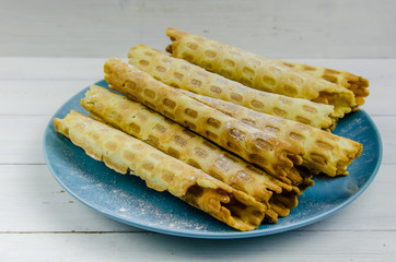 homemade waffle tubes on a blue plate