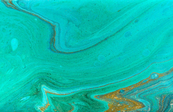 Beautiful simple light blue marble background with layers of gold glitter.