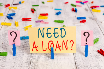 Writing note showing Need A Loan Question. Business concept for asking he need money expected paid back with interest Crumbling sheet with paper clips placed on the wooden table