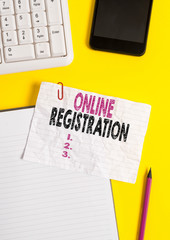 Text sign showing Online Registration. Business photo text System for subscribing or registering via the Internet Crumpled white paper on table with paper clips clock mobile and pc keyboard