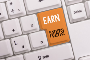 Text sign showing Earn Points. Business photo text collecting scores in order qualify to win big prize White pc keyboard with empty note paper above white background key copy space