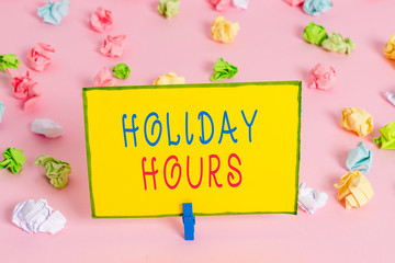 Word writing text Holiday Hours. Business photo showcasing employee receives twice their normal pay for all hours Colored crumpled papers empty reminder pink floor background clothespin