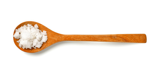 Salt in wood spoon on white background