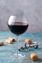A glass with red wine. The concept of winemaking. Place under your text. Still life on a textural background.