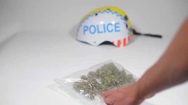 a pack of cannabis in hand at police