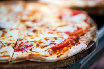 close-up pizza on wooden plate , selective focus