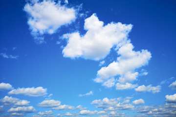 Naklejka na ściany i meble White beautiful fluffy clouds on blue sky background. The blue sky concept