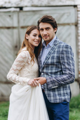 A young couple of brides have a fun and walking in the field outdoor