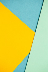 Photo of colored sheets of paper: yellow, orange, blue, green. Suitable for design templates,...