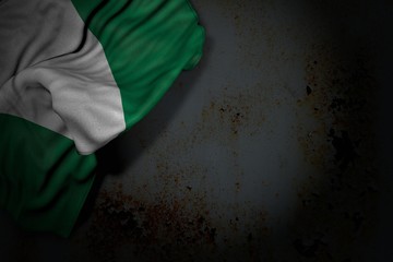 wonderful dark image of Nigeria flag with big folds on rusty metal with empty place for content - any occasion flag 3d illustration..