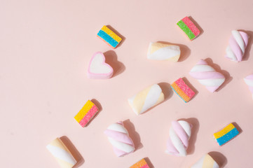 Colorful pink cute top view flat lay background with candies and marshmallow