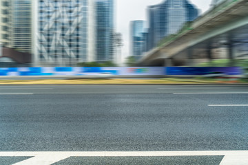 empty asphalt road near glass office building