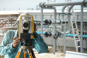 construction ideas concept engineer Surveyor with Level camera  at new construction site