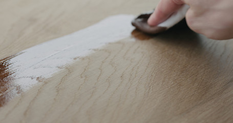 applying oil finish to oak surface with cloth