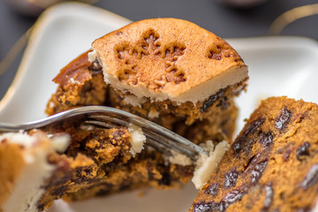closeup view christmas mini cake crushed with fork on star shape plate with decorations