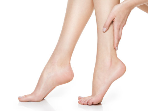 Beautiful women feet isolated on white. Close-up.