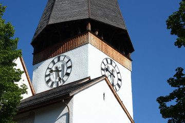 Close-up from the clock and tower of the church in Saanen, Switzerland, in summer 2019