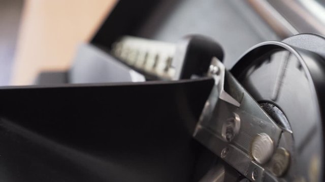 Coins from vending machine rolling inside coin sorter and counter. Close up.