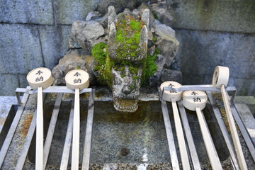 The ladles for water in a ritual hand-washing well at Japanese Temple