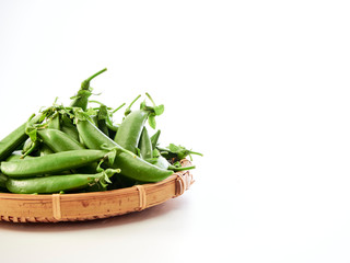 green pea pod In a bamboo container