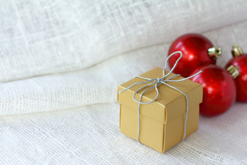 holiday gift on a background of red balls. getting ready for christmas