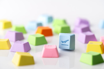 Colorful travel icon on computer keyboard for online booking concept