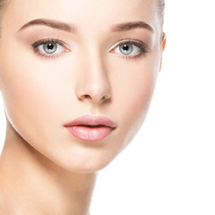 Obraz premium Beautiful face of young woman with healthy clean skin