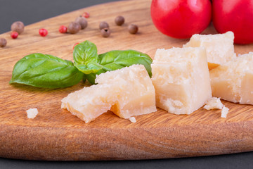 Pieces of Rigiano parmesan, cherry tomato and basil leaf