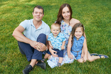 Fototapeta premium family mom, father, son and daughter in the park