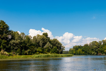 Summer landscape with beautiful river, green trees and blue sky